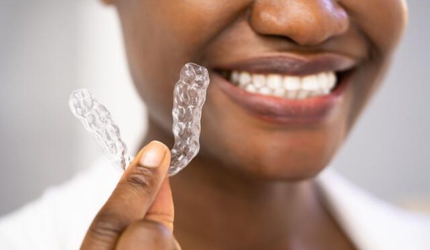 woman holding invisalign